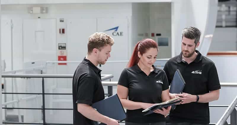 asg team members looking at documents